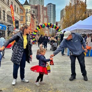 halloween bash; child in costume with caregiver